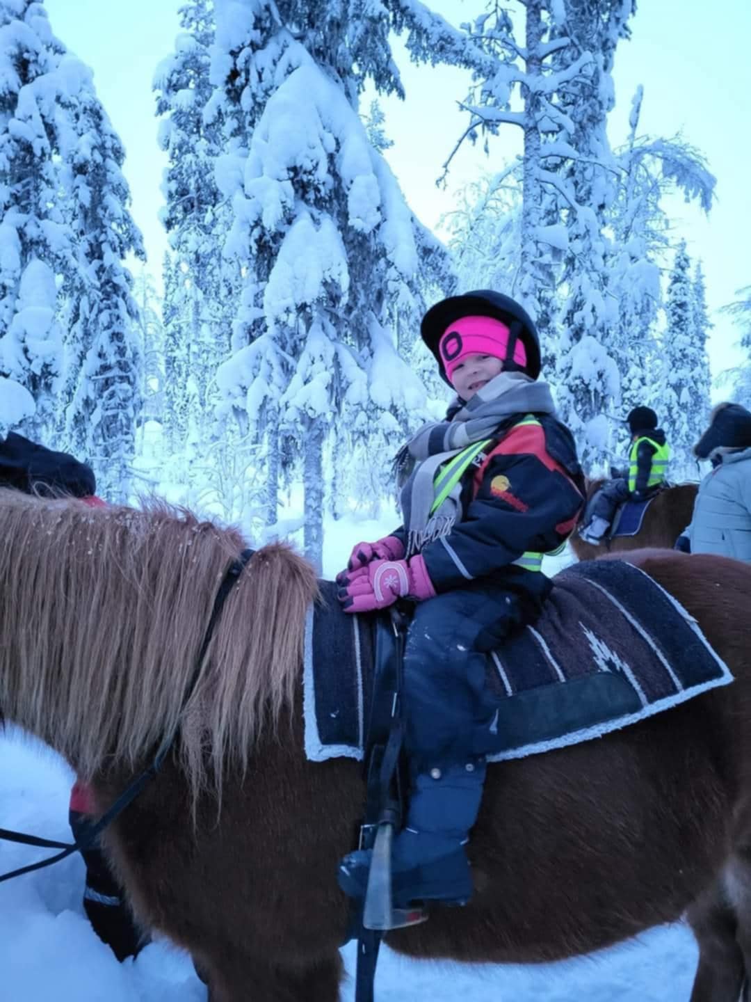 image of a girl sat on a horse in the snow<br />
